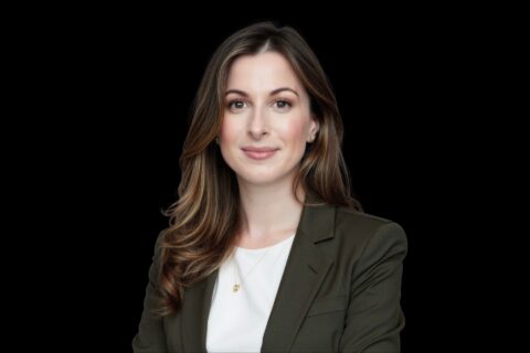 Woman in business suit against black background