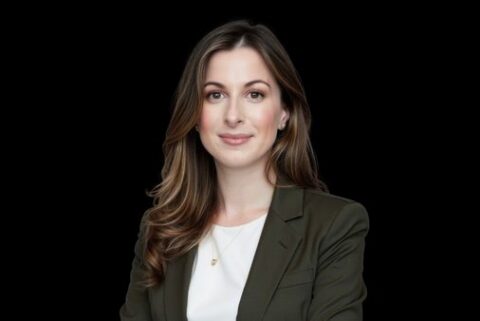 woman in business suit against black background